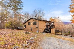 a small house in the middle of a field at River Access Cabin with Hot Tub, Fire Pit, & WiFi! in Morton Grove