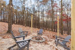 three benches sitting around a fire pit in a park at River Access Cabin with Hot Tub, Fire Pit, & WiFi! in Morton Grove