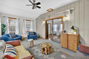 a living room with a couch and a table at River Access Cabin with Hot Tub, Fire Pit, & WiFi! in Morton Grove +41 photos