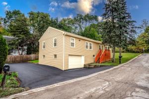 a house with a garage on a driveway at The Main Stay - Mineola Bay Lakeview and Access - Fully Furnished Monthly & Seasonal Rental in Fox Lake in Fox Lake
