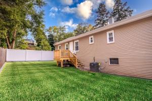 a yard with a house and a fence at The Main Stay - Mineola Bay Lakeview and Access - Fully Furnished Monthly & Seasonal Rental in Fox Lake in Fox Lake