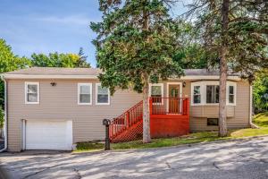 a house with an orange fence in front of it at The Main Stay - Mineola Bay Lakeview and Access - Fully Furnished Monthly & Seasonal Rental in Fox Lake in Fox Lake