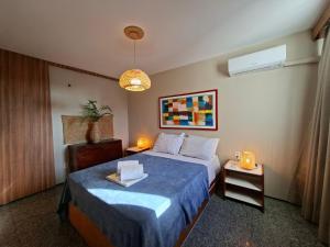 a hotel room with a bed with a blue blanket at Flat Atlântico Meireles by Escala in Fortaleza +59 photos