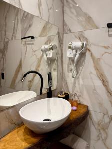 a bathroom with a white sink and a mirror at Cantinho do Vale# in Pomerode +18 photos