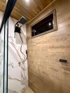 a bathroom with a shower with a window at Cantinho do Vale# in Pomerode