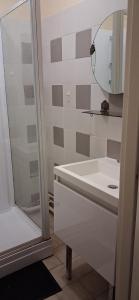 a white bathroom with a sink and a mirror at Chambre privée dans grand et superbe appartement proche paris in Creil