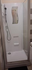 a shower with a glass door in a bathroom at Chambre privée dans grand et superbe appartement proche paris in Creil