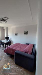 a bedroom with a large bed and a table at A Casa di Nonna Lidia in Crotone