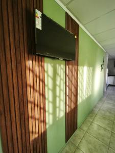 una camera con una parete con una televisione sul muro di Posada 25 a San Rafael