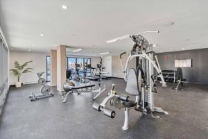 a gym with several treadmills and exercise bikes at Corporate Stays Millennium Boulevard 1 Bedroom in Moncton