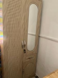 a wooden door with a mirror in a room at Beach house villa in Kokrobite