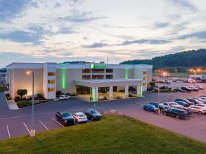 an aerial view of a hotel with cars parked in a parking lot at Holiday Inn Morgantown - Reading Area by IHG in Morgantown