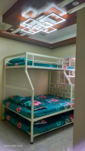 a bedroom with two bunk beds in a room at J Jireh Residences in San Jose del Monte