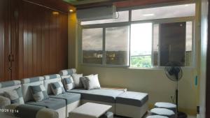 a waiting room with a couch and a window at J Jireh Residences in San Jose del Monte