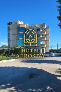 a hotelagency sign in front of a building at Aerostay Hotel in Rinas