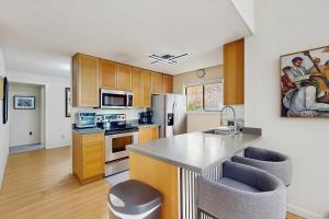 a kitchen with wooden cabinets and a counter top at Twin Ponds in Oak Bluffs