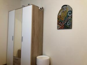 a bathroom with a toilet and a mirror at Artistic Neon Apartment in Bansko +12 photos