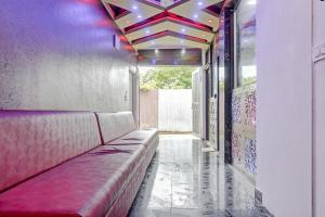 a couch in a hallway with a ceiling with lights at Hotel O CeeRock in Bhopal
