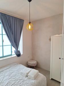 a bedroom with a bed and a window at מעיינות האהבה in Reshafim