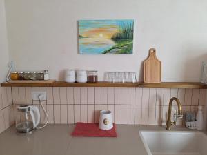 a kitchen with a counter top with a sink and a counter top at מעיינות האהבה in Reshafim