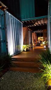 a porch of a building at night with a fence at Loft Girassol in Palhoça