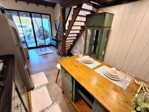 a kitchen with a table with plates and wine glasses at Loft Girassol in Palhoça +2 photos