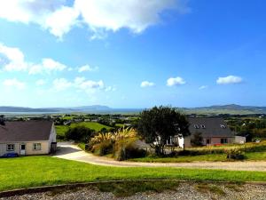 a view from the hill of a house at 4 Bedroom House By Travel Lets Holiday Homes Carrigart With Sea View in Carrigart