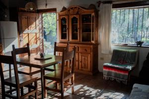 a kitchen with a table and chairs and a dining room at La Mata de Nuez in Valle de Guadalupe