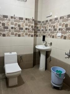 a bathroom with a toilet and a sink at Wonder View in Shimla