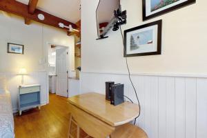 a living room with a table with a television on it at Sparkling Sands Holiday House M2 in Moody
