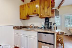 a kitchen with wooden cabinets and a sink at Sparkling Sands Holiday House M2 in Moody