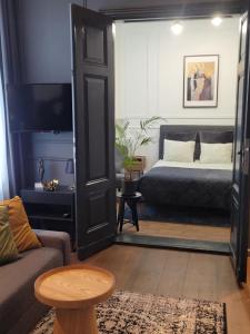 a bedroom with a bed and a couch and a table at Hej Bydgoszcz - Apartament LUX przy Starym Rynku in Bydgoszcz