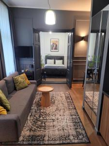a living room with a couch and a bed at Hej Bydgoszcz - Apartament LUX przy Starym Rynku in Bydgoszcz