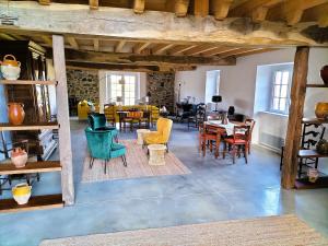 a living room with chairs and tables in a building at Maison basque de charme avec piscine in Souraïde