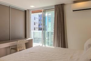 a bedroom with a bed and a large window at Flat à beira-mar Solar Tambaú - MyFlats in Tambaú +26 photos