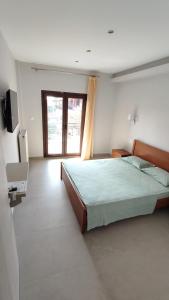 een slaapkamer met een groot bed en een raam bij House Evristhenis 1 in Toroni