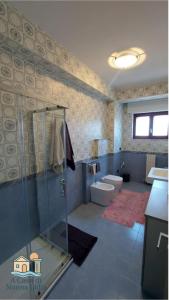 a bathroom with a shower and a toilet and a sink at A Casa di Nonna Lidia in Crotone