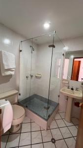 a bathroom with a shower and a toilet and a sink at El Gran Hotel in Chiquinquirá