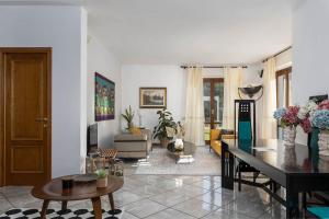 a living room with a table and a dining room at Villa Luisa Design in Colle Val D'Elsa