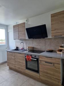 a kitchen with a stove and a counter top at Proche rocade sud in Rennes