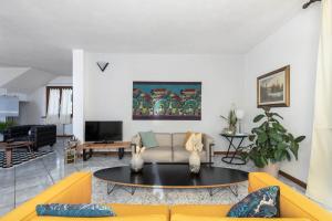 a living room with a couch and a table at Villa Luisa Design in Colle Val D'Elsa