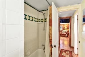a bathroom with a white tub and a shower at Rare Log Cabin Treasure Close to Grand Canyon Now with Wi-Fi in Parks