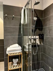 a bathroom with a shower with a glass door at T2 élégant & confortable, balcon - Amiens centre in La Celle-sous-Gouzon