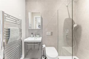 a bathroom with a shower and a toilet and a sink at Lambert House Two in Harrogate