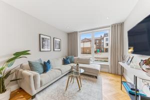a living room with a couch and a large window at Lambert House Two in Harrogate