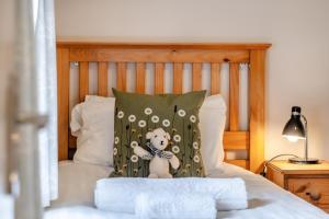 a teddy bear on a pillow on a bed at 2 Bed in Whitwell oc-o33499 in Whitwell