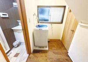 a small bathroom with a toilet and a window at Tabata Flower Village - Vacation STAY 45929v in Tokyo