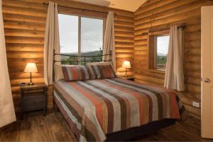 a bedroom with a bed and a window at Ontario Ave Remodeled Log Cabin on 1 Acre Gateway to Grand Canyon Amazing Views in Williams