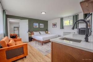 a kitchen with a couch and a bed in a room at The Inn at Shady Pines in Gros Cap