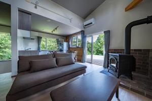 a living room with a couch and a fireplace at NISEKO Mt,Village - Vacation STAY 65414v in Kaributo